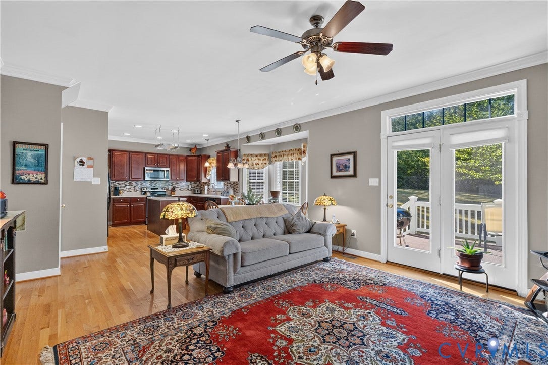 3647 Cedar Plains Road, Sandy Hook, Sandy Hook, VA 23153 Open-concept living area featuring wood-finish flooring, a ceiling fan with integrated lighting, and crown molding