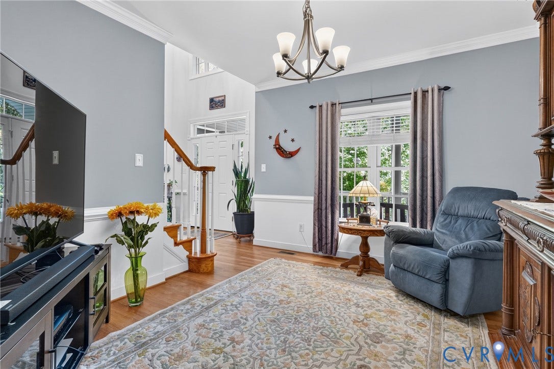 3647 Cedar Plains Road, Sandy Hook, Sandy Hook, VA 23153 Hardwood flooring, crown molding, chair rail molding, a prominent window, and a chandelier with an upward-facing light design