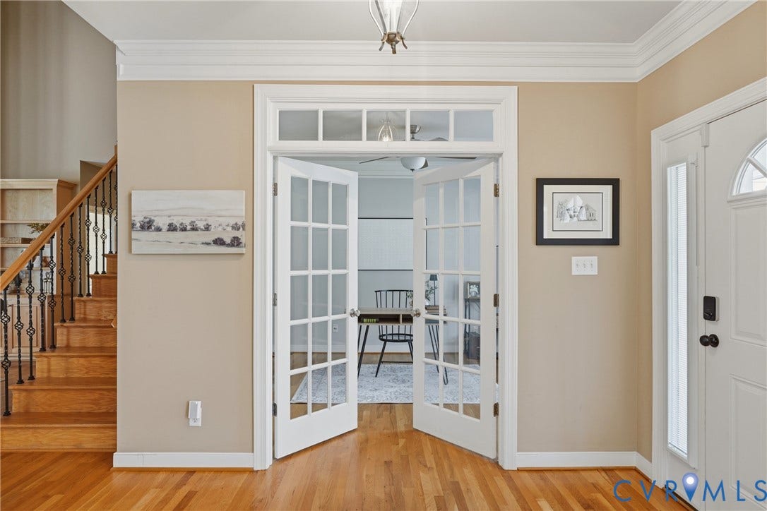 11813 Longfellow Drive, Bayhill Pointe, Midlothian, VA 23112 Interior entryway featuring wood-finish flooring, double glass-paneled French doors with a transom window, and a staircase with an ornamental metal balustrade