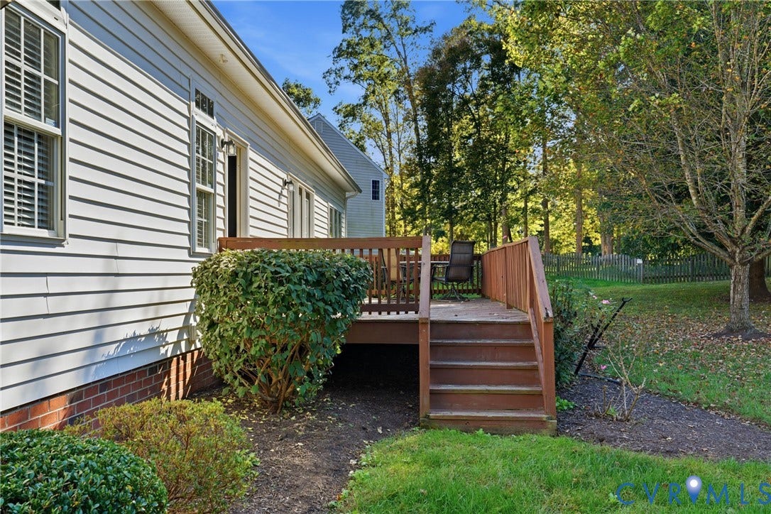 11813 Longfellow Drive, Bayhill Pointe, Midlothian, VA 23112 Rear exterior featuring horizontal lap siding, brick foundation, raised wood deck with integrated stairs, and landscaped yard