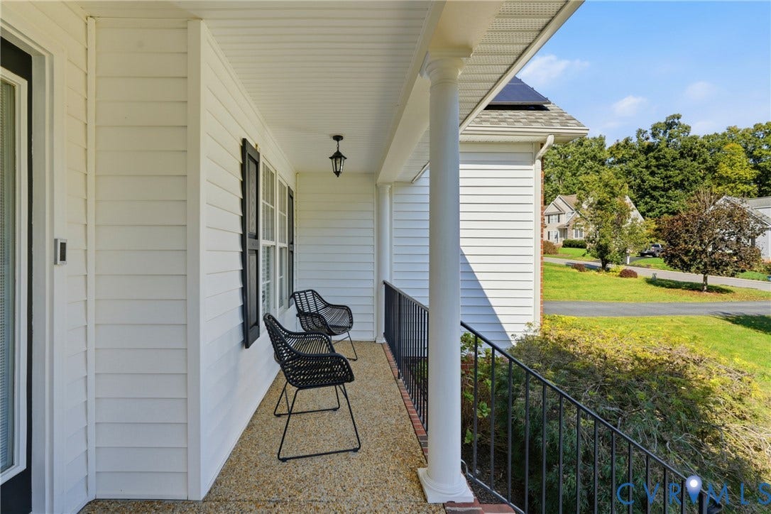 11813 Longfellow Drive, Bayhill Pointe, Midlothian, VA 23112 Covered front porch featuring white horizontal siding, round support columns, a textured aggregate floor, and black metal railings