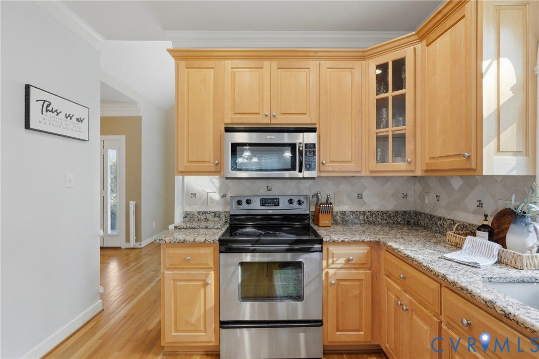 11813 Longfellow Drive, Bayhill Pointe, Midlothian, VA 23112 Kitchen featuring light wood cabinetry, stone countertops, stainless steel appliances, a glass-panel cabinet door, and chevron-patterned backsplash tile