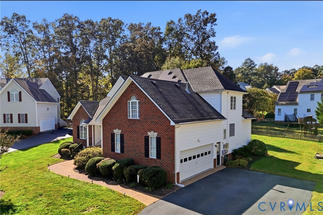11813 Longfellow Drive, Bayhill Pointe, Midlothian, VA 23112 Multi-level exterior featuring a brick and siding facade, an attached two-car garage, asphalt shingle roofing, and a paved driveway
