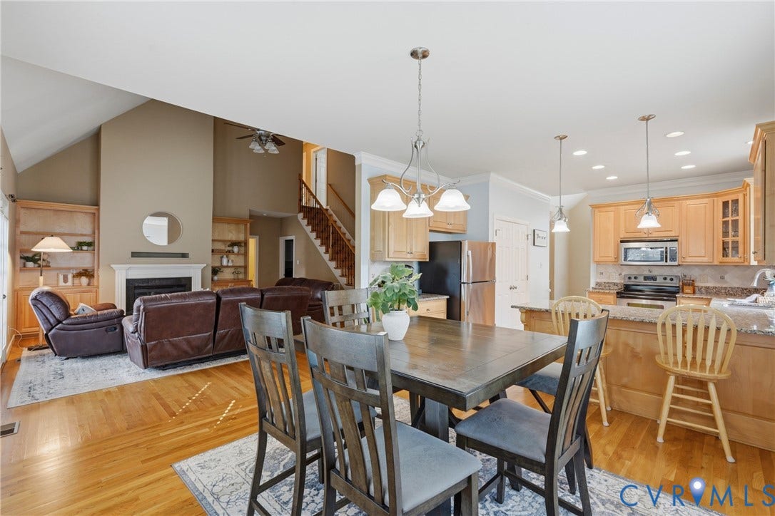 11813 Longfellow Drive, Bayhill Pointe, Midlothian, VA 23112 Vaulted ceilings, wood-finish flooring, fireplace with custom built-in shelving, wooden cabinetry, and recessed lighting