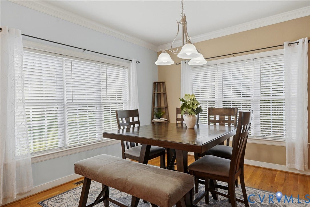 11813 Longfellow Drive, Bayhill Pointe, Midlothian, VA 23112 Multi-window dining area featuring crown molding, hardwood flooring, and a three-light chandelier