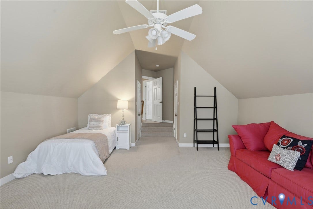 11813 Longfellow Drive, Bayhill Pointe, Midlothian, VA 23112 Vaulted ceiling featuring a white multi-blade ceiling fan with integrated lighting and wall-to-wall carpeting
