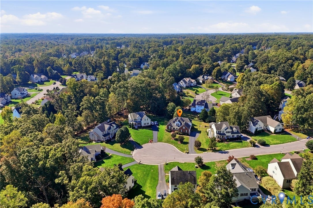 11813 Longfellow Drive, Bayhill Pointe, Midlothian, VA 23112 Aerial perspective of a multi-story residence situated on a cul-de-sac lot, featuring an attached multi-car garage, steep-pitched roofline, and established mature tree canopy