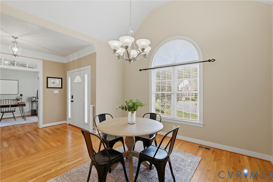 11813 Longfellow Drive, Bayhill Pointe, Midlothian, VA 23112 Vaulted ceilings, wood-finish flooring, an arched window, and a multi-arm chandelier
