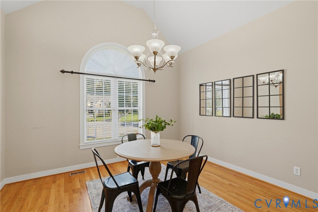 11813 Longfellow Drive, Bayhill Pointe, Midlothian, VA 23112 Vaulted ceilings featuring an arched window, wood-finish flooring, and a multi-arm chandelier