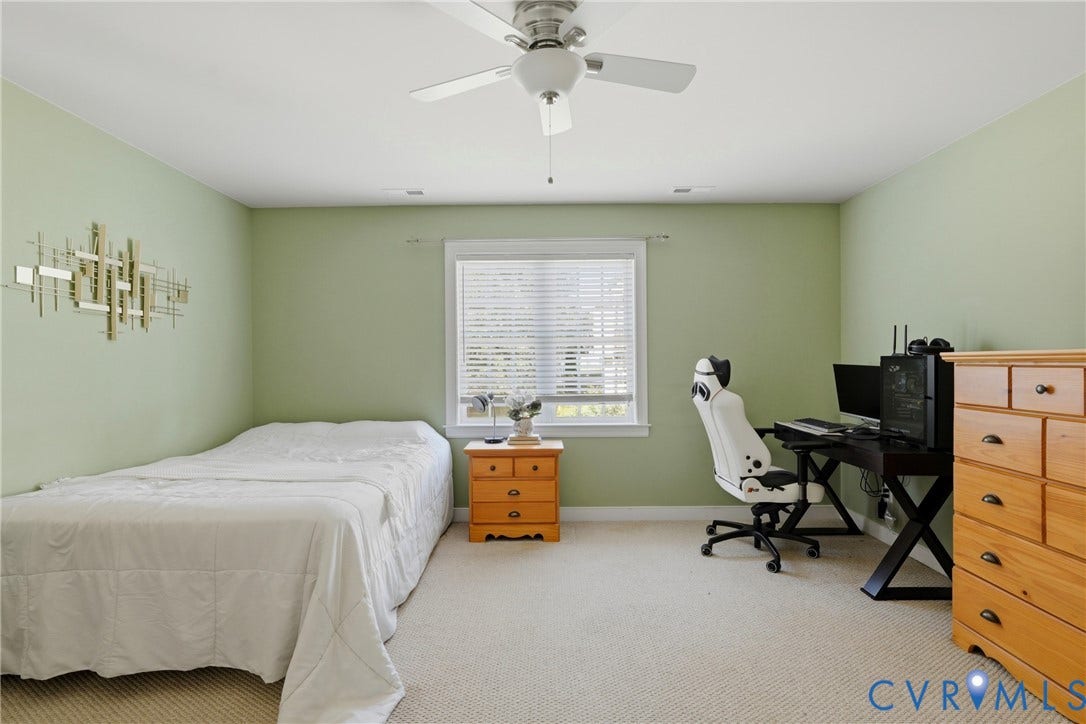 11813 Longfellow Drive, Bayhill Pointe, Midlothian, VA 23112 Room featuring neutral-toned carpeting, a center-mounted ceiling fan with light fixture, and a central window with slatted blinds