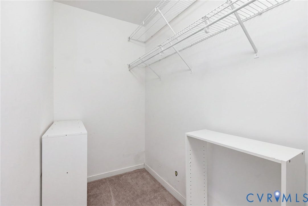 2803 Queensland Drive, #2803, Pemberton Oaks, Glen Allen, VA 23294 Storage area featuring white wire shelving units, carpeted flooring, and white built-in cabinetry