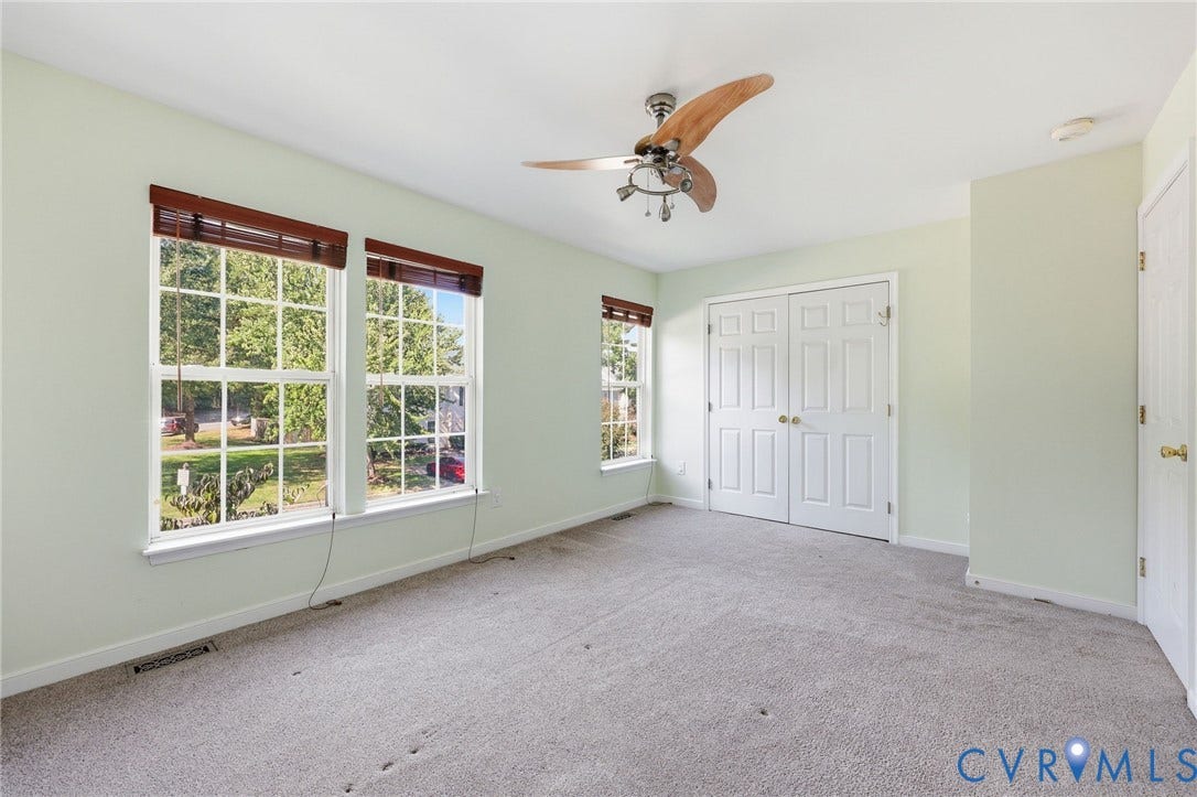 2803 Queensland Drive, #2803, Pemberton Oaks, Glen Allen, VA 23294 Room featuring wall-to-wall carpeting, dual-pane windows with grid mullions, wooden-finish ceiling fan with integrated lighting, and double-door closet cabinetry