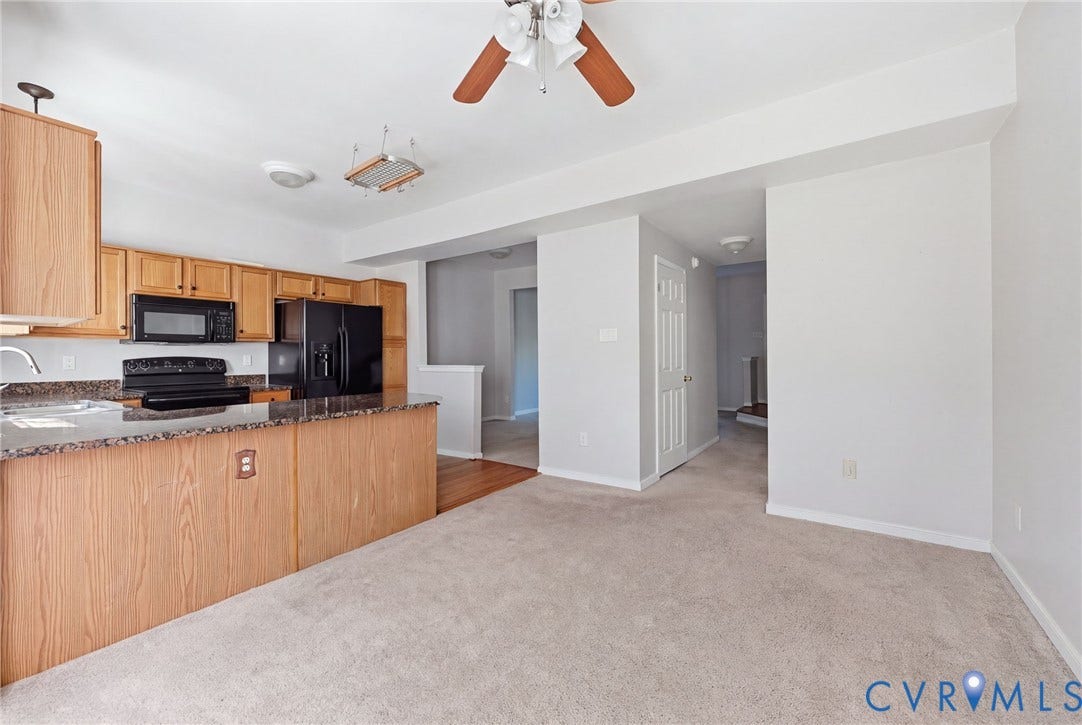2803 Queensland Drive, #2803, Pemberton Oaks, Glen Allen, VA 23294 Kitchen featuring wood cabinetry, stone-finish countertops, a black built-in microwave, a black range, and a ceiling fan