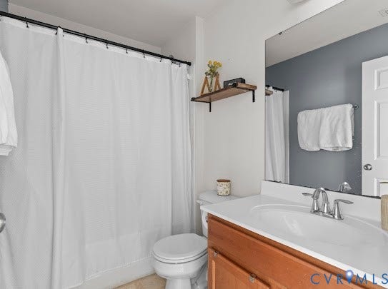 Single vanity with integrated sink, chrome faucet, and wood-finish cabinetry