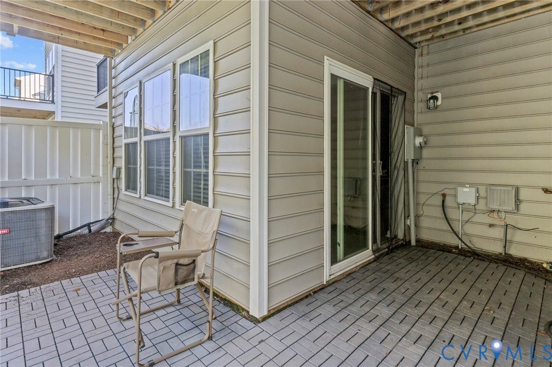 Exterior patio with modular tile flooring and sliding glass door access