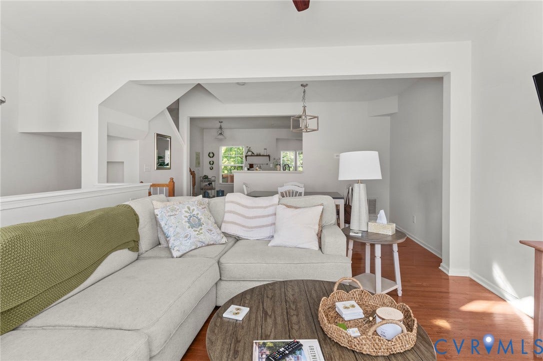 Hardwood flooring, white painted walls, and an open concept architectural design