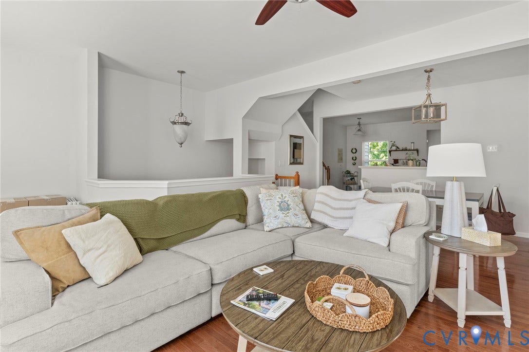 Hardwood-finish flooring throughout, integrated ceiling fan, recessed wall niche, and an open-concept layout