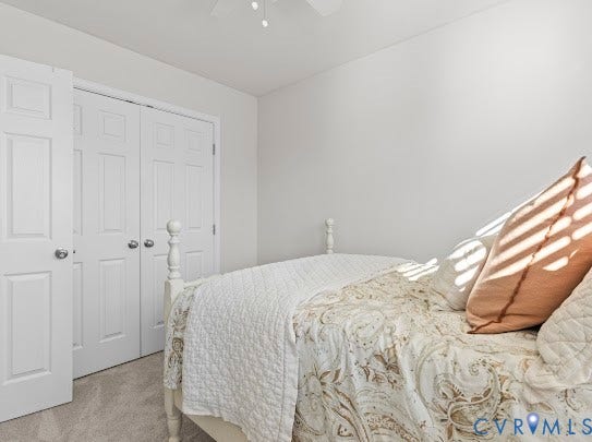 White interior walls, light-toned carpet, and a ceiling-mounted light fixture