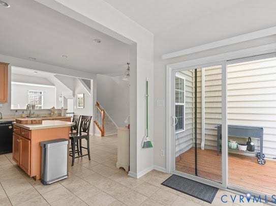 Kitchen island with wood-finish cabinetry and a light-colored countertop