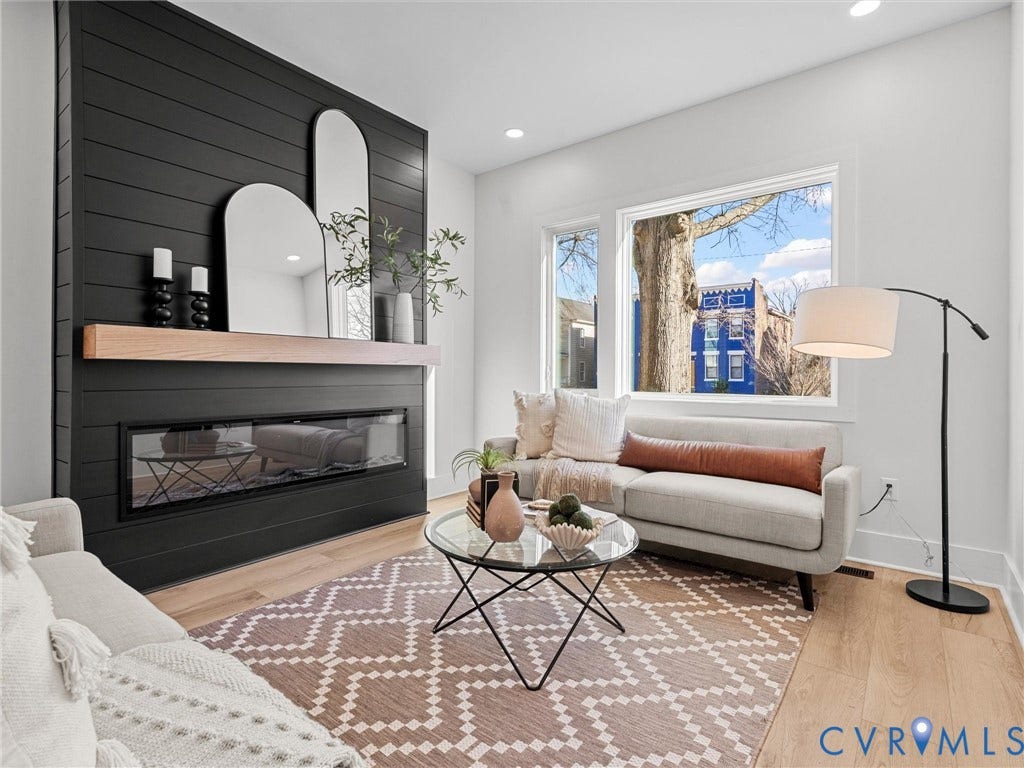 2202 3rd Avenue, Northside, Richmond, VA 23222 Living area featuring a shiplap fireplace surround with a linear electric fireplace, wood mantel, and light wood-finish flooring