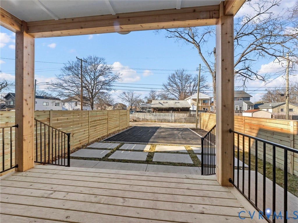 2202 3rd Avenue, Northside, Richmond, VA 23222 Covered outdoor patio with wood decking, square concrete pavers, and black metal railings