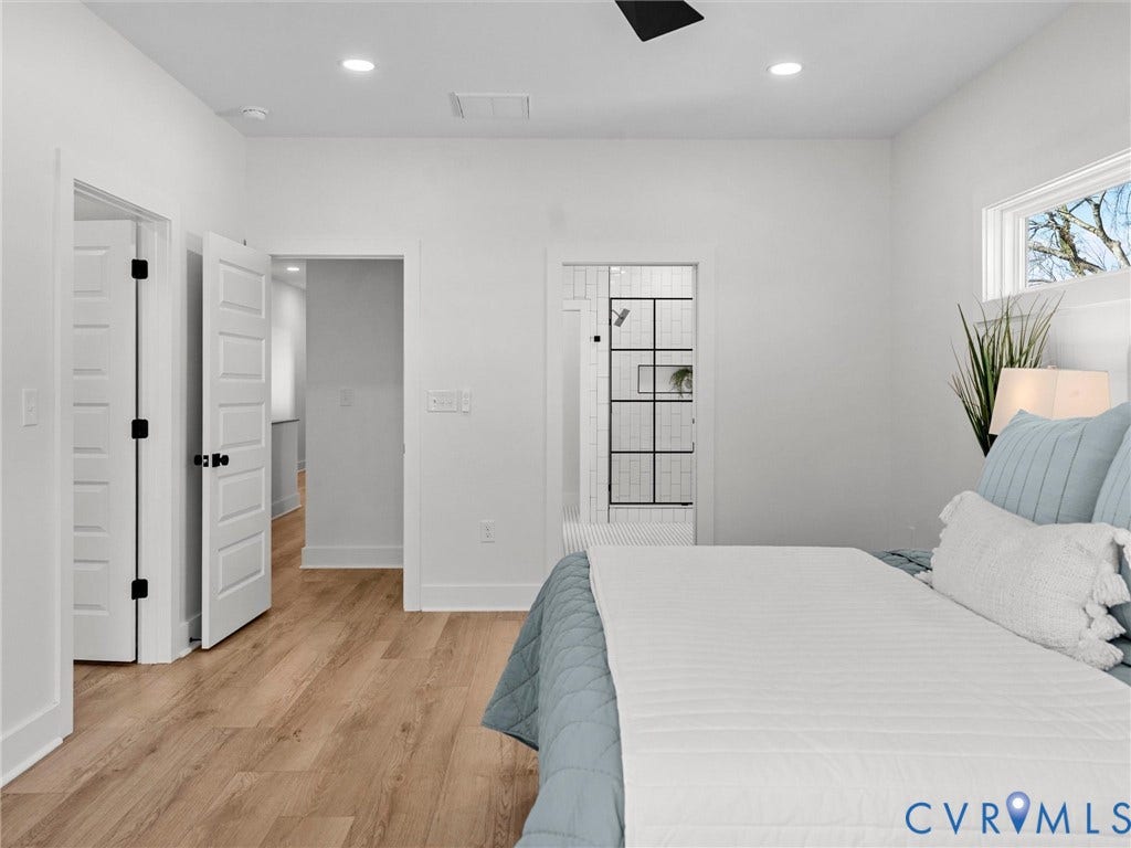 2202 3rd Avenue, Northside, Richmond, VA 23222 Recessed ceiling lighting, wood-finish flooring, white paneled doors with matte black hardware, white trim, and a window with white casing