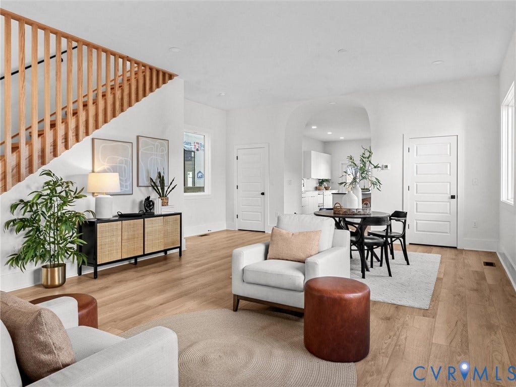 2202 3rd Avenue, Northside, Richmond, VA 23222 Wood-finish flooring, white walls, natural wood staircase railing, arched doorway, and recessed lighting