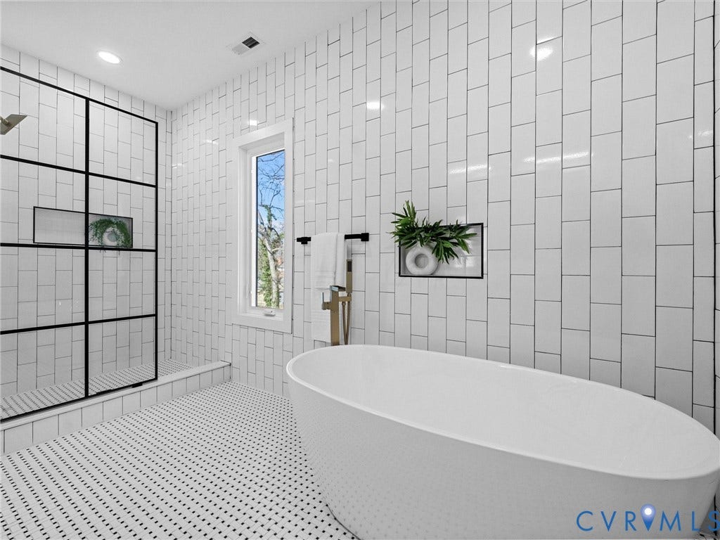 2202 3rd Avenue, Northside, Richmond, VA 23222 Freestanding soaking tub, floor-to-ceiling subway tile, walk-in shower with grid-patterned glass enclosure, recessed shower shelf, and small pane window