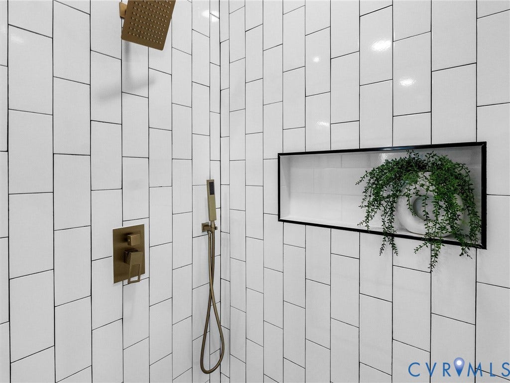 2202 3rd Avenue, Northside, Richmond, VA 23222 Vertical subway tile shower walls with a built-in shower niche and bronze-finish fixtures