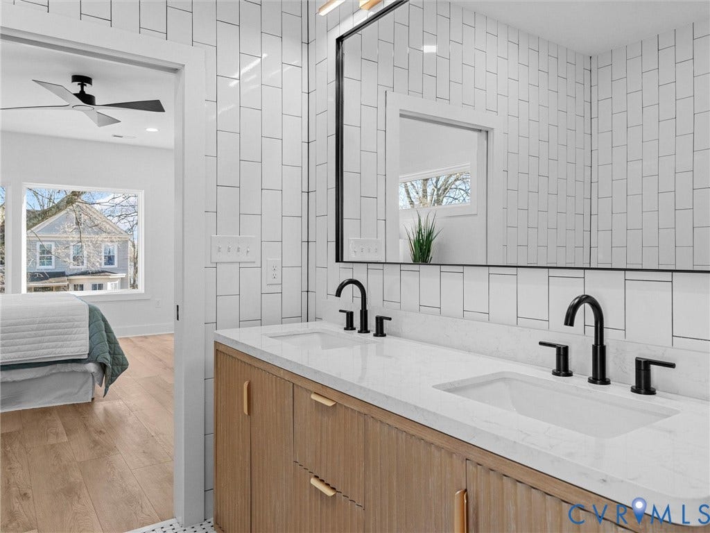 2202 3rd Avenue, Northside, Richmond, VA 23222 Double vanity with integrated sinks, matte black fixtures, and a light wood-finish cabinet