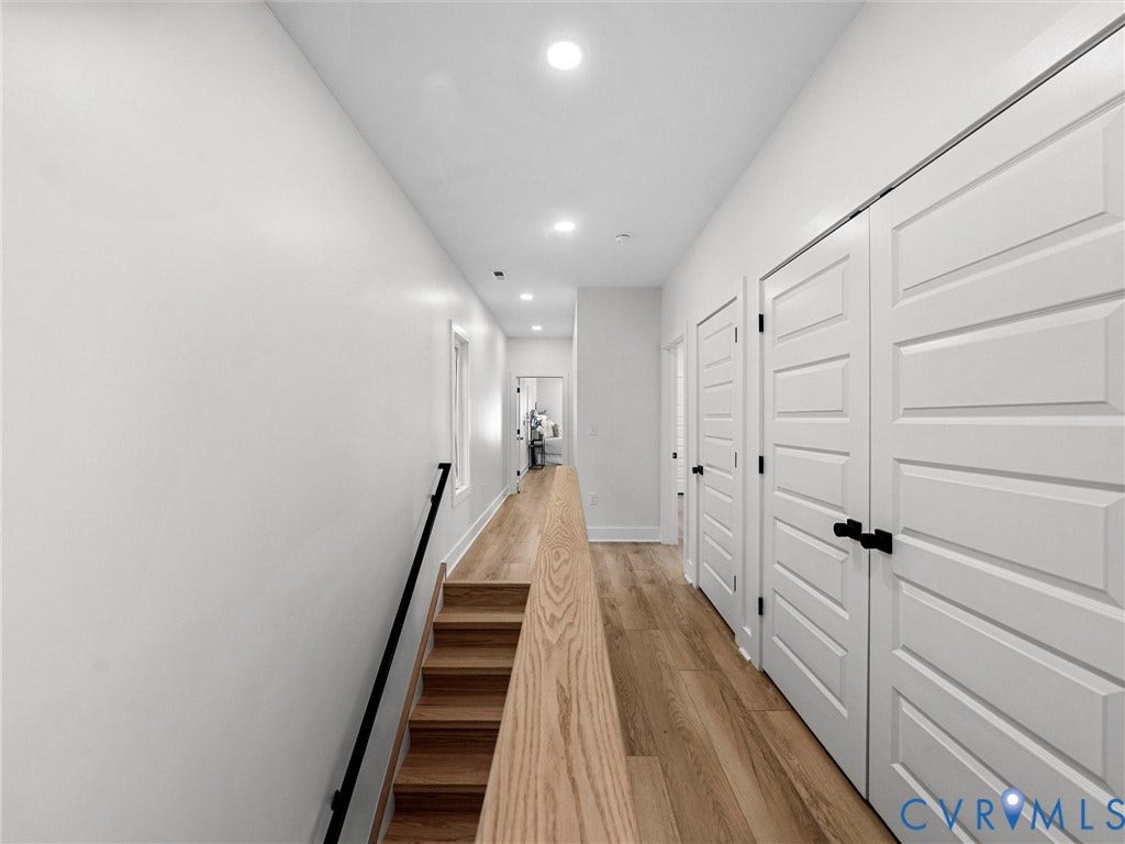 2202 3rd Avenue, Northside, Richmond, VA 23222 Wood-finish flooring, recessed ceiling lighting, light wood stair railing, black metal handrail, and white panel doors with black hardware