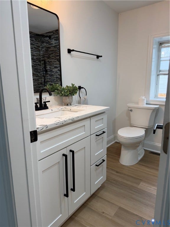 2311 T Street, Richmond, VA 23223 White cabinetry with black hardware, stone-composite countertop, rectangular undermount sink, matte black faucet fixtures, and wood-finish flooring
