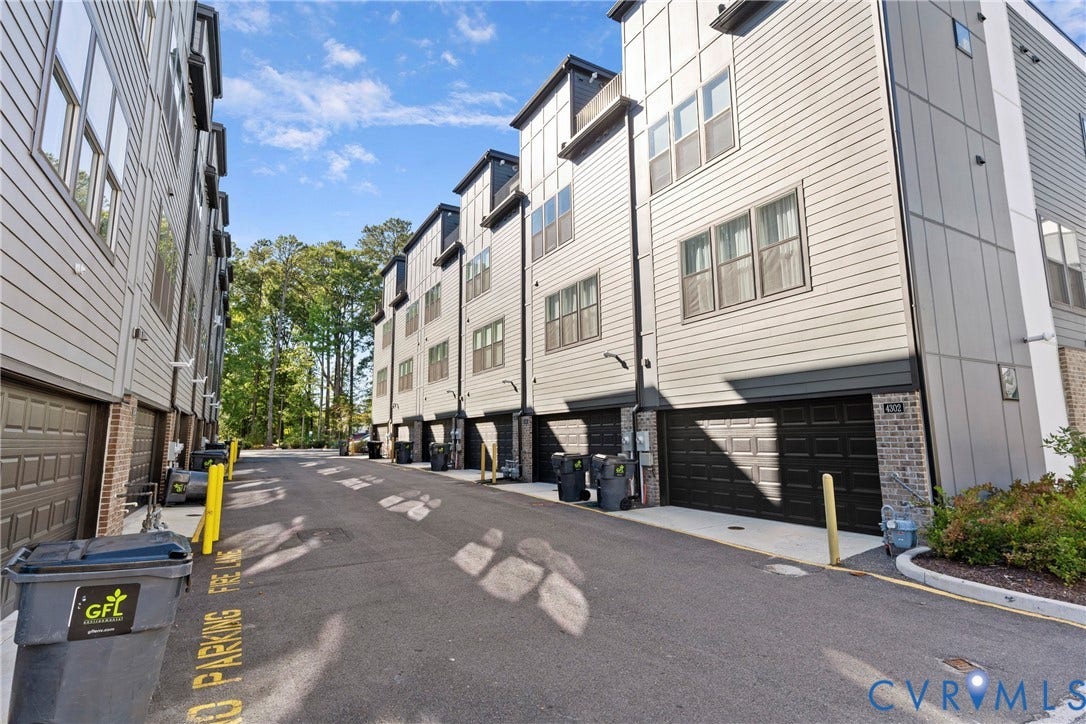 Modern townhome community featuring contemporary architectural design with clean siding finishes, stepped rooflines, and ground-level garage access
