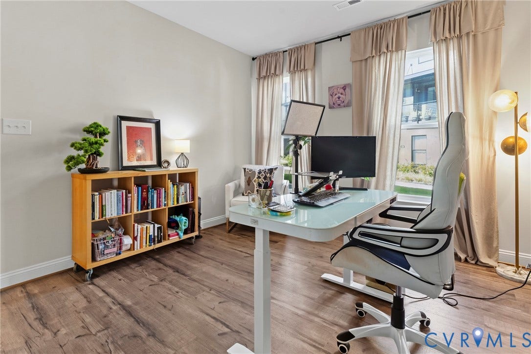 Light-toned walls complement wood-finish flooring, creating a bright atmosphere