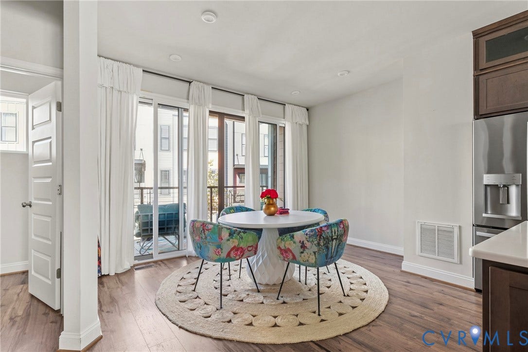 Wood-finish flooring, recessed lighting, and a white paneled door