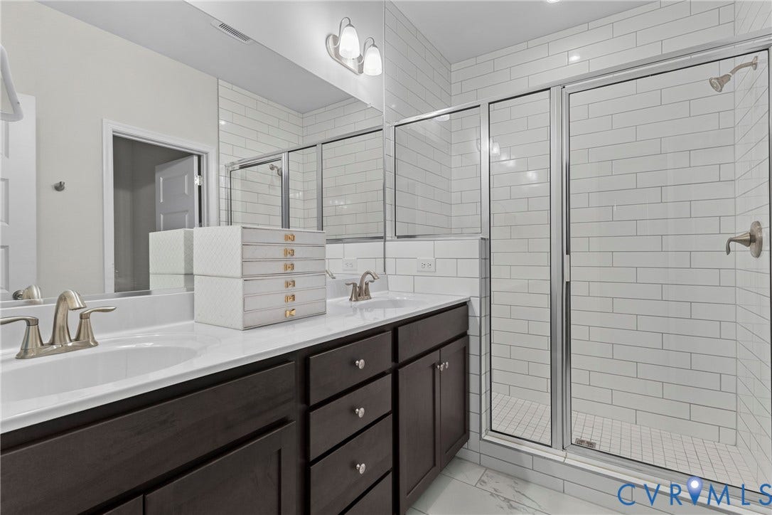 Dual vanity with undermount sinks and dark wood cabinetry