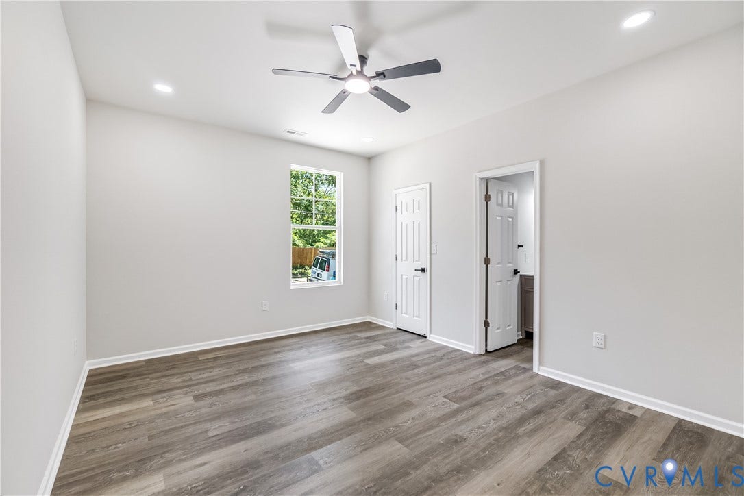 Wood-finish flooring, recessed lighting, ceiling fan, and white doors