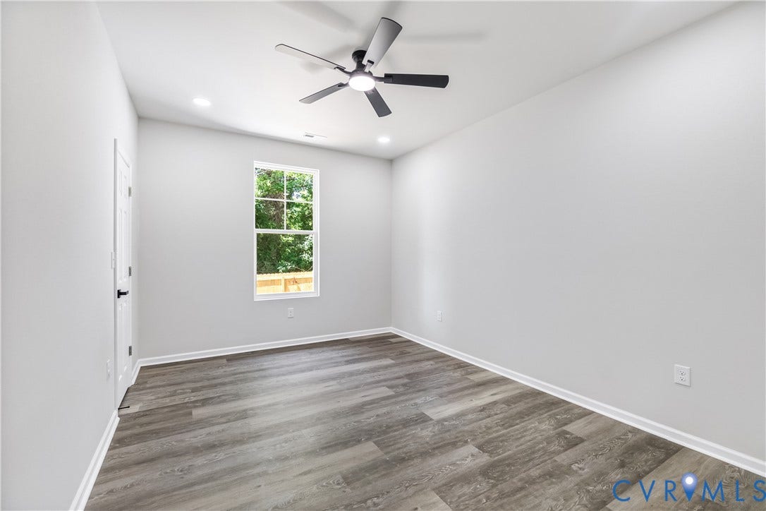 Wood-finish flooring, recessed lighting, and a ceiling fan with integrated lighting