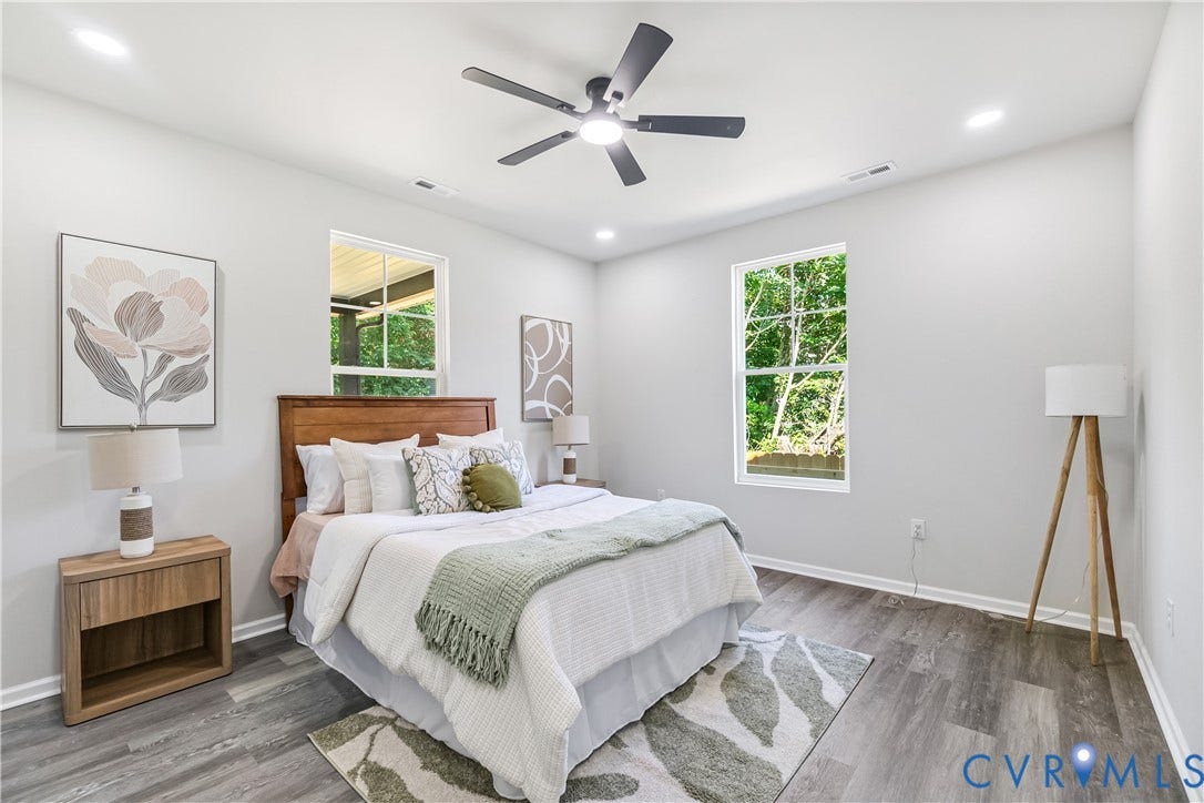 Wood-finish flooring, recessed lighting, and a ceiling fan with integrated light