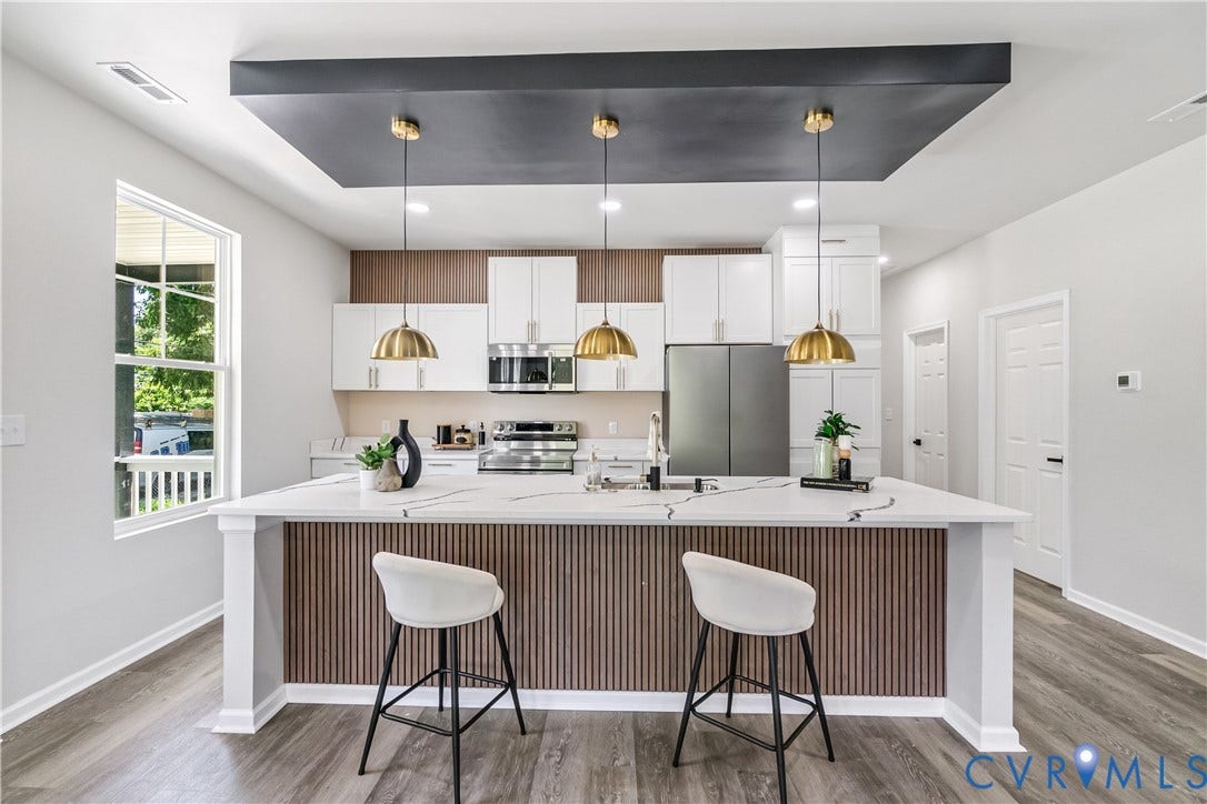 Kitchen island featuring a wood-finish slatted base and a white countertop