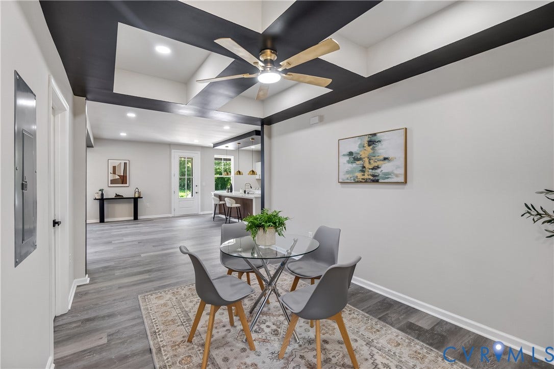 Vaulted ceiling with accent beams and ceiling fan, recessed lighting, wood-finish flooring, white trim, and a white paneled door
