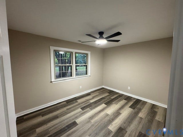 Wood-finish flooring, neutral wall tones, and a ceiling fan with integrated lighting