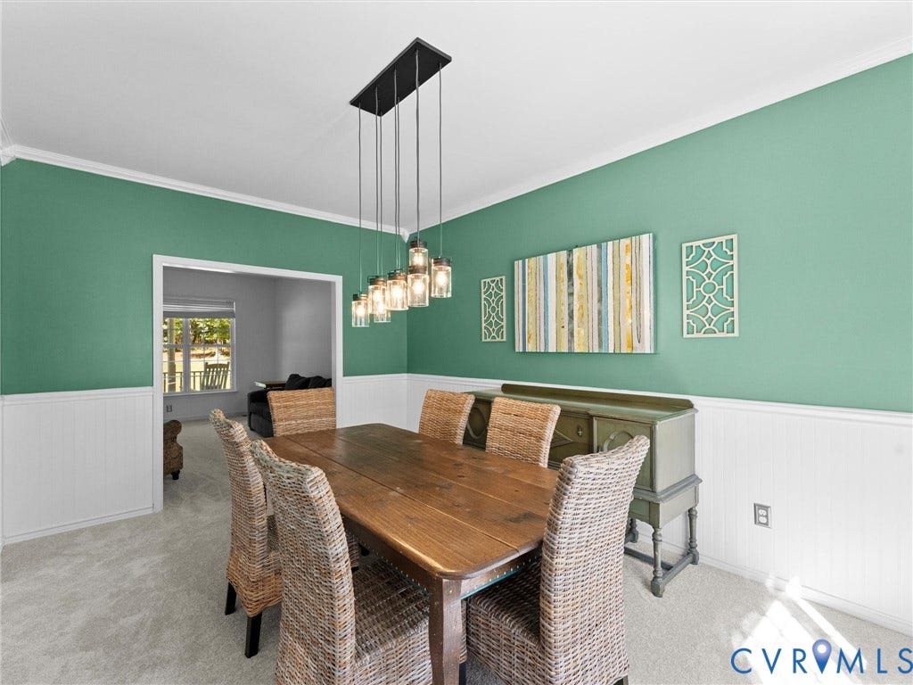 Recessed lighting, crown molding, chair rail molding, and a rectangular chandelier with glass jar pendants