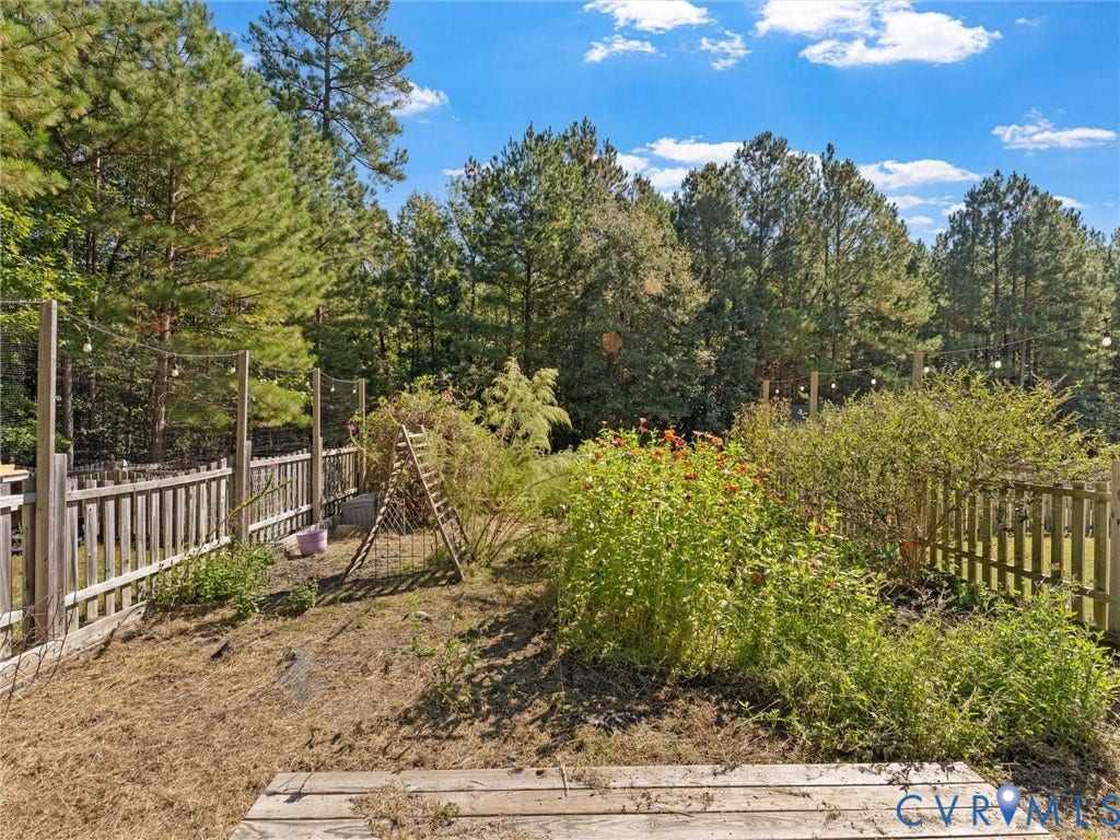 Landscaped garden area with established plantings and a wood fence border