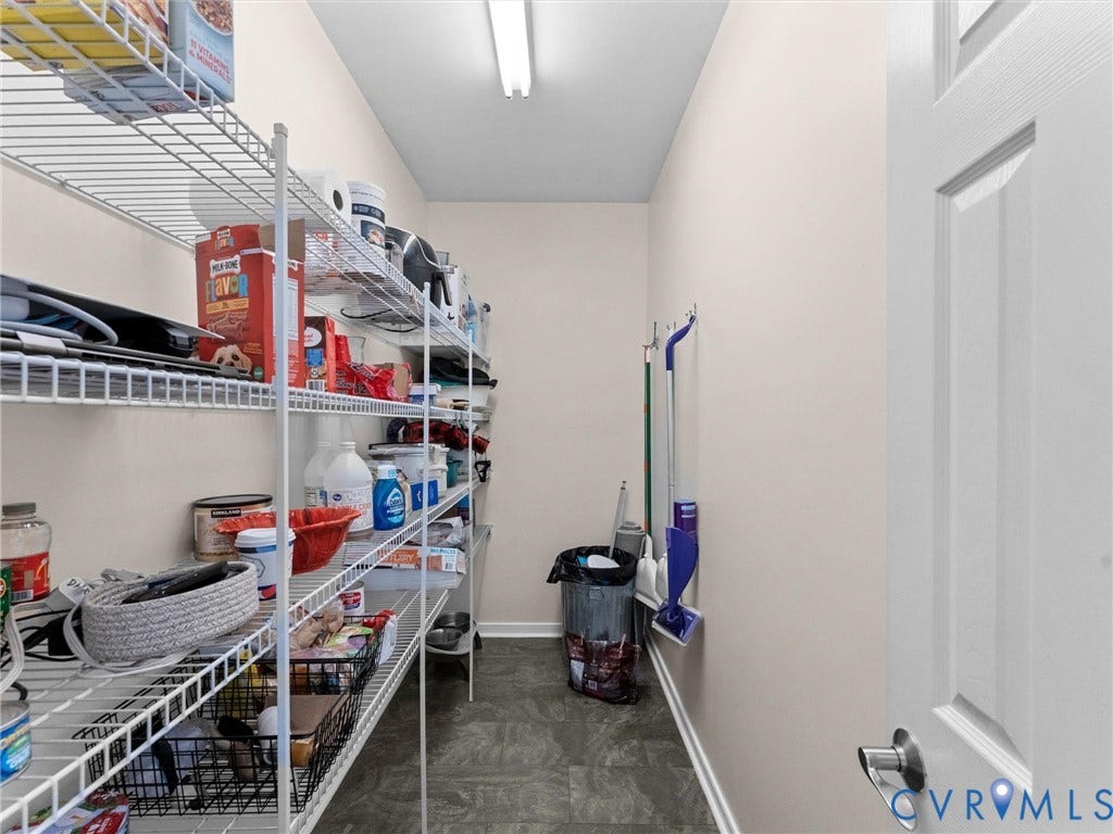 Recessed pantry with wire shelving, light-toned walls, and a closed-panel door