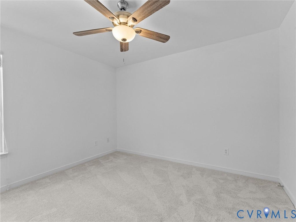 Recessed lighting with a ceiling fan, light-toned carpeting, and a window with vertical blinds