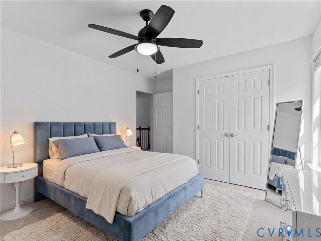 Recessed ceiling fan with integrated lighting, white paneled doors, and light-colored carpeting