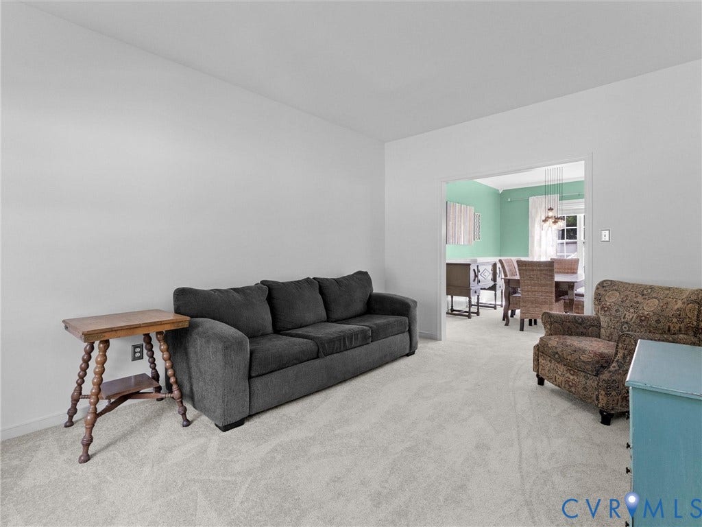 Wall-to-wall carpeting throughout, with a wide cased opening leading to an additional space