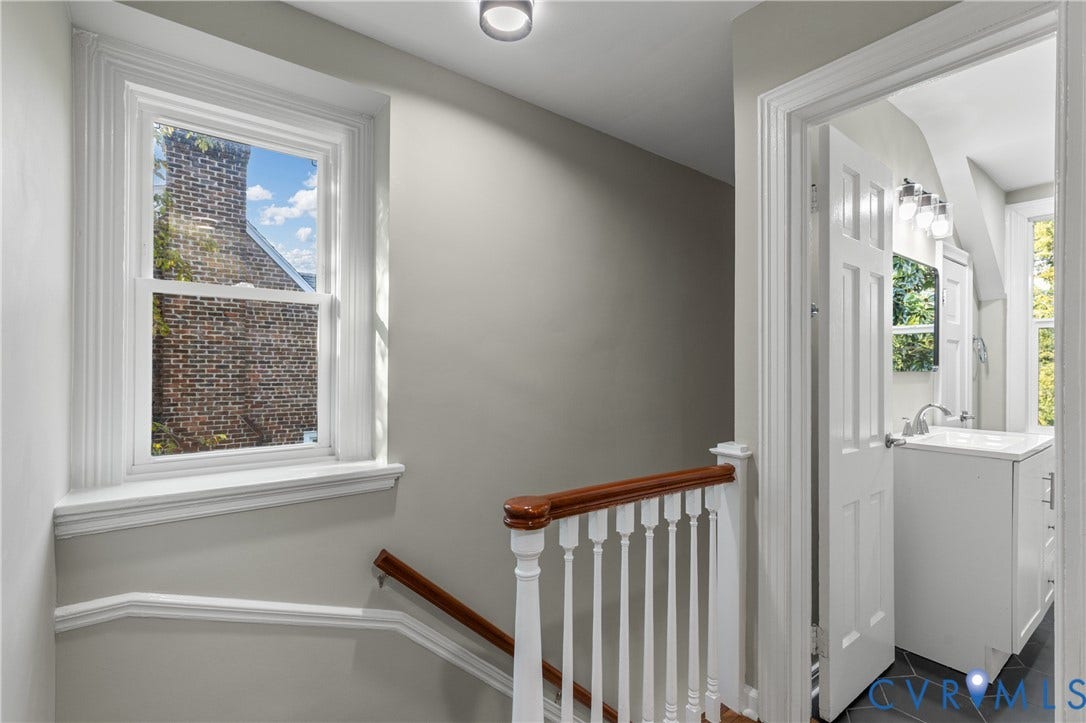 2606 Hawthorne Avenue, Richmond, VA 23222 Hardwood handrail, white balusters, and window with detailed trim