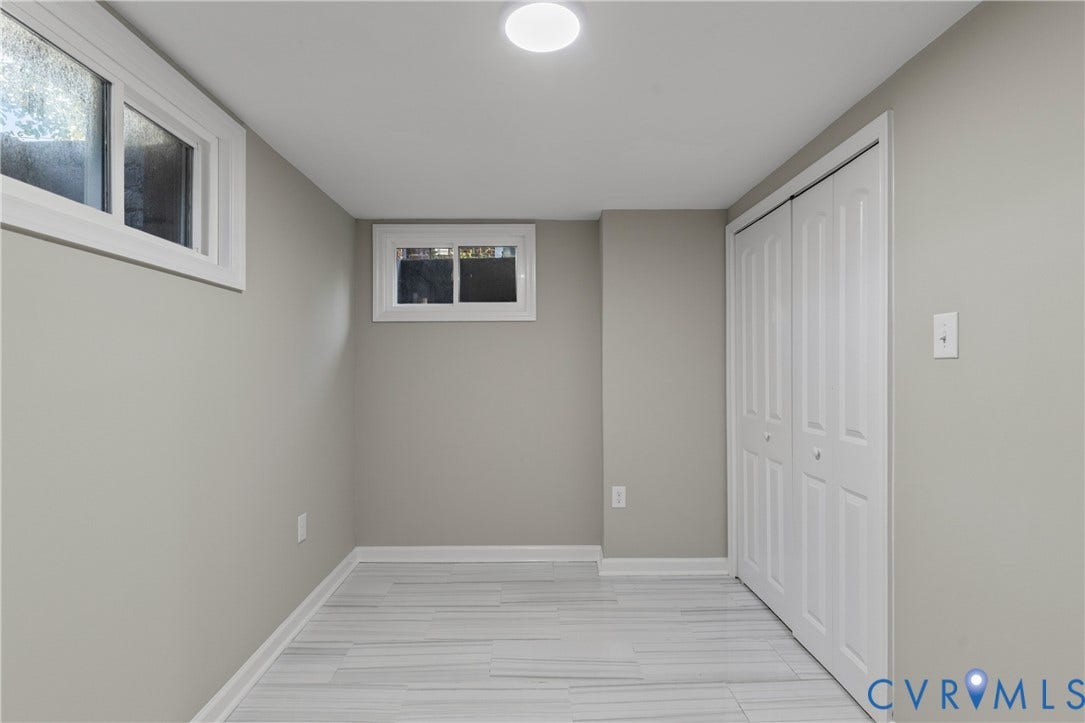 2606 Hawthorne Avenue, Richmond, VA 23222 Recessed ceiling lighting, two windows, bi-fold closet doors, light gray wall paint, and wood-finish flooring